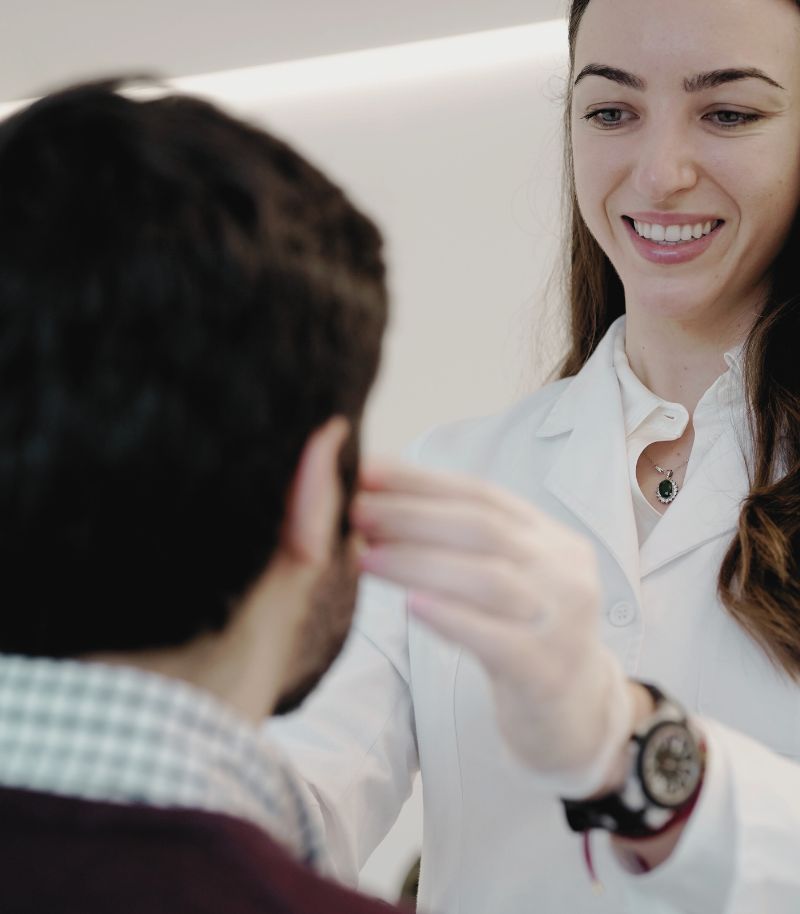 Dermatologist assessing skin texture before Laser Me treatment