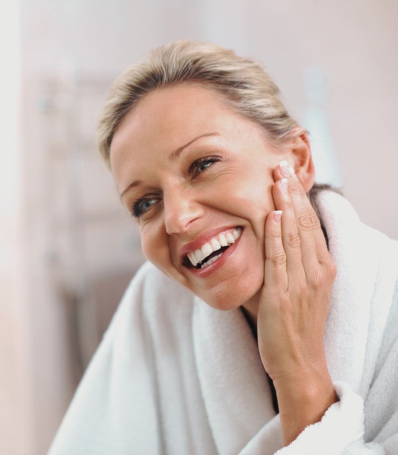 Visible results with no downtime Woman smiling with radiant skin, showing visible results after Clear & Brilliant laser treatment with no downtime.